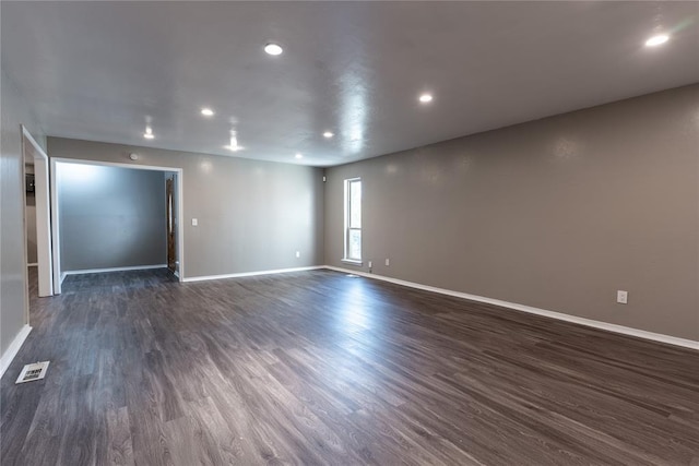 spare room with dark hardwood / wood-style flooring