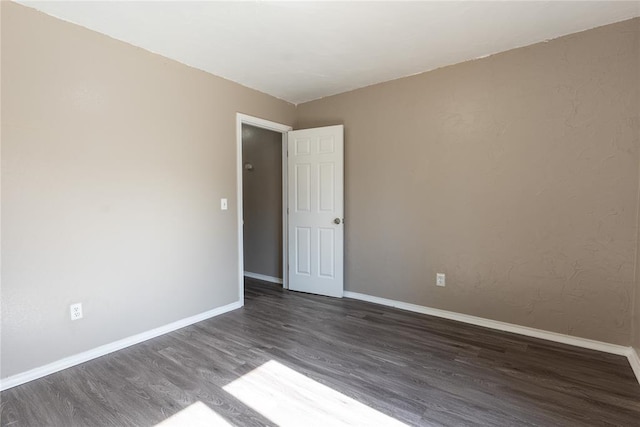 unfurnished room featuring dark hardwood / wood-style flooring