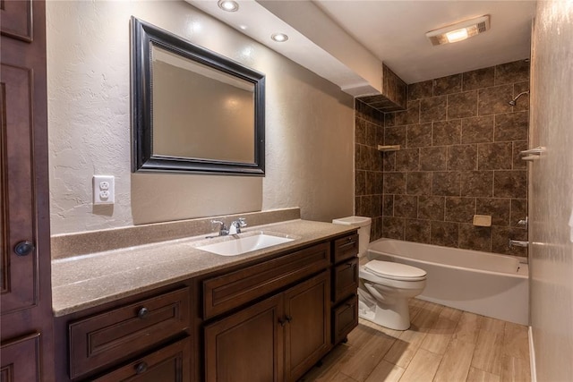 full bathroom featuring vanity, toilet, and tiled shower / bath combo