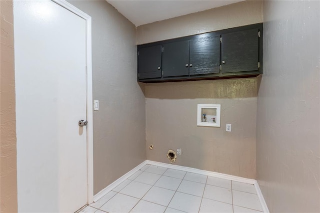 laundry area with cabinets, washer hookup, and light tile patterned flooring