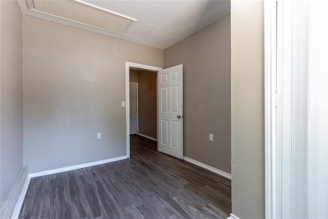 empty room with dark wood-type flooring