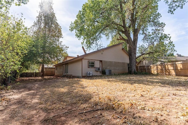 back of house featuring cooling unit