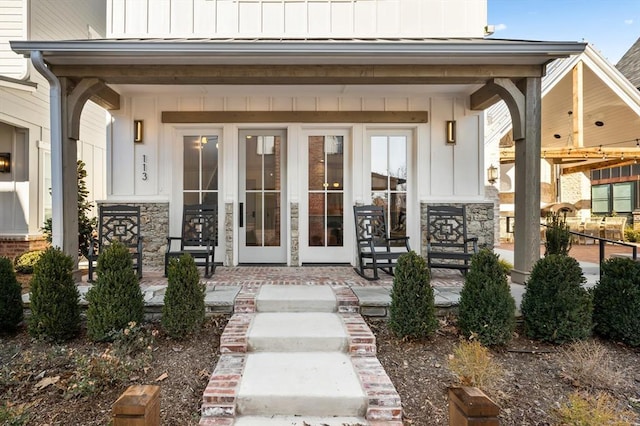 doorway to property featuring covered porch