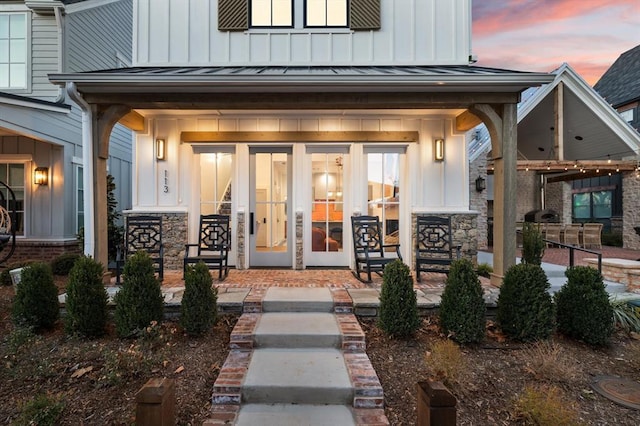 exterior entry at dusk featuring covered porch