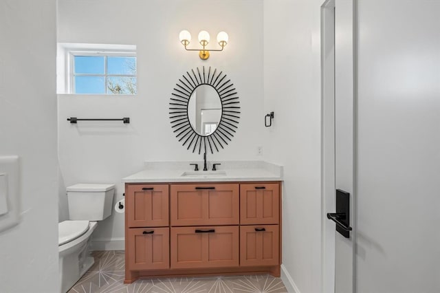 bathroom featuring toilet, vanity, and tile patterned floors