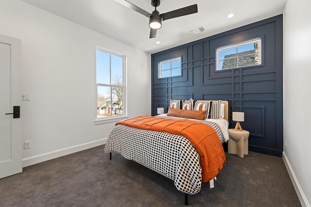 carpeted bedroom featuring ceiling fan and multiple windows