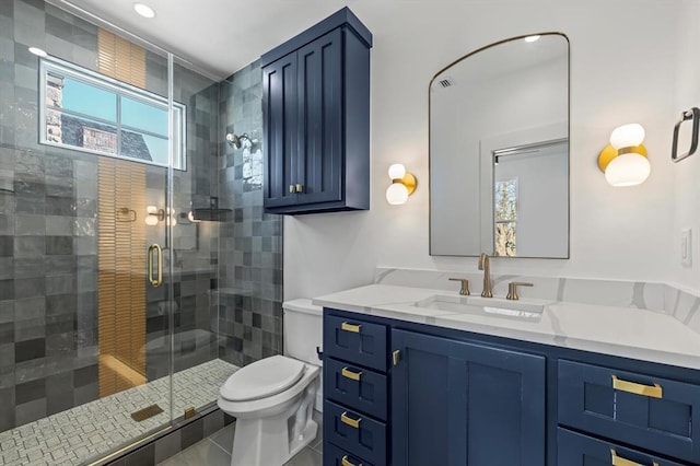 bathroom featuring toilet, vanity, and walk in shower