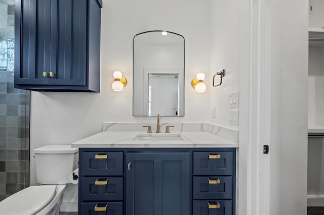 bathroom with walk in shower, vanity, and toilet