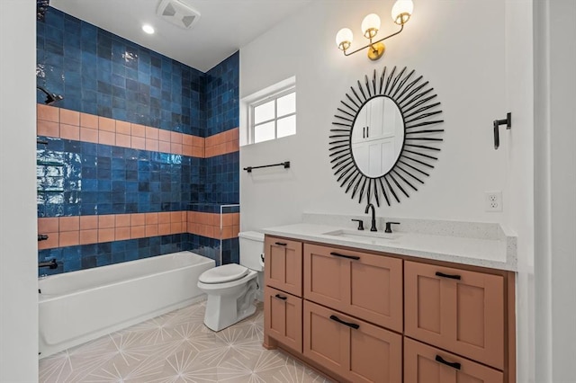 full bathroom with toilet, tiled shower / bath, and vanity