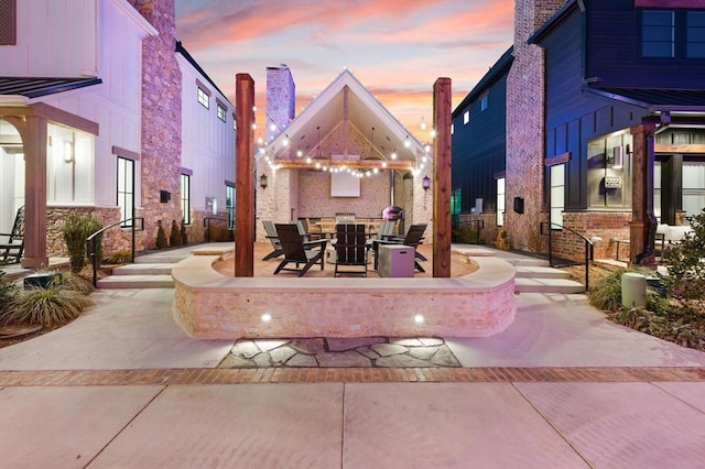 view of patio terrace at dusk