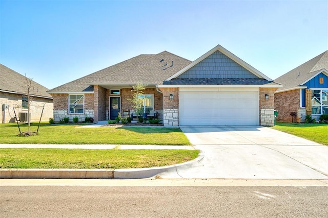 view of front of home featuring a front yard, a garage, and cooling unit