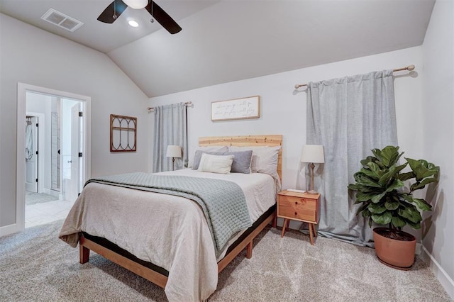 carpeted bedroom featuring lofted ceiling, ensuite bath, and ceiling fan