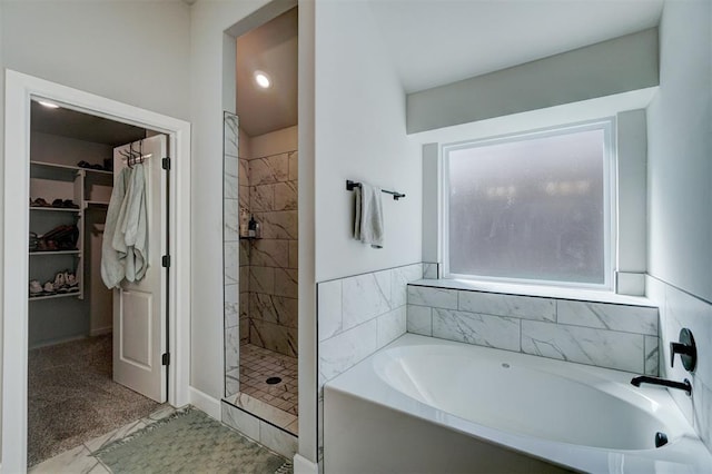 bathroom with separate shower and tub