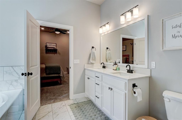 bathroom with vanity, ceiling fan, and a tub