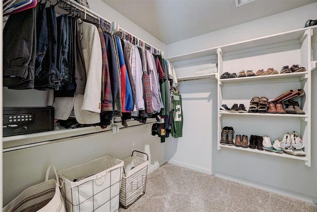 walk in closet with light colored carpet