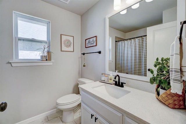 bathroom with tile patterned floors, vanity, and toilet