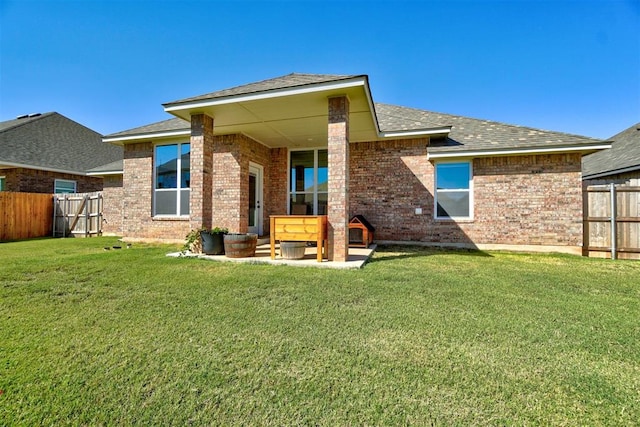 back of property with a lawn and a patio area