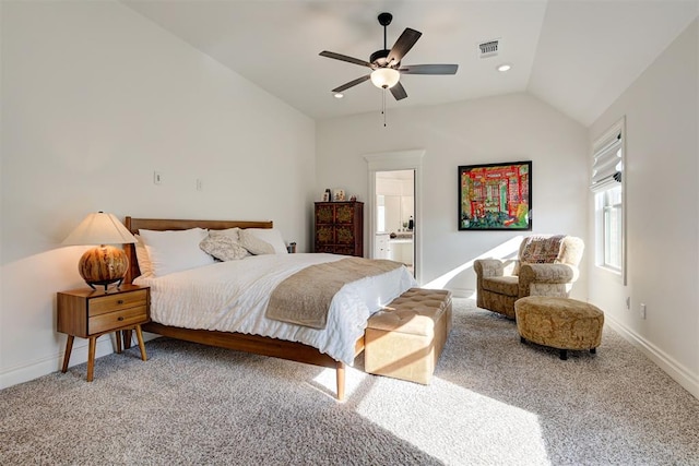 carpeted bedroom with ceiling fan, lofted ceiling, and ensuite bath