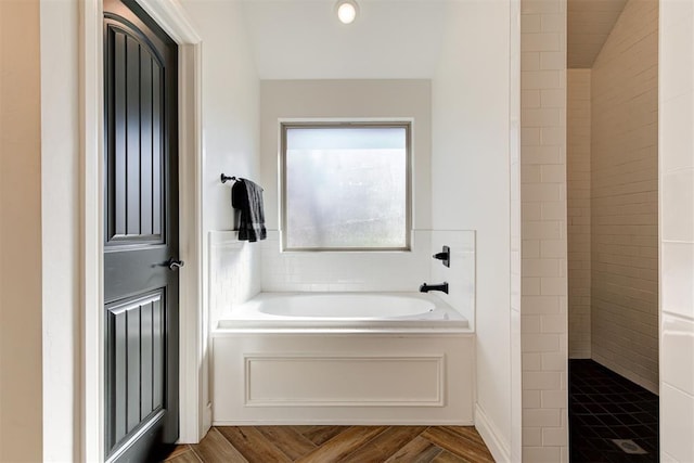 bathroom with wood-type flooring and plus walk in shower