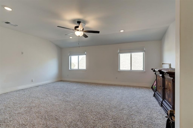 carpeted empty room with vaulted ceiling and ceiling fan