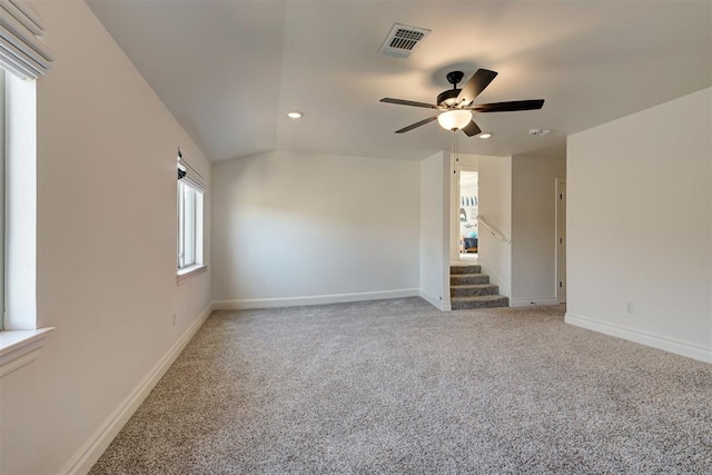 carpeted empty room featuring ceiling fan and lofted ceiling