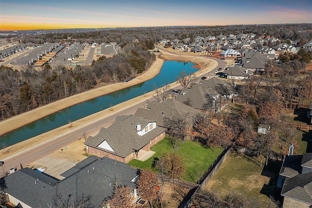 aerial view at dusk with a water view