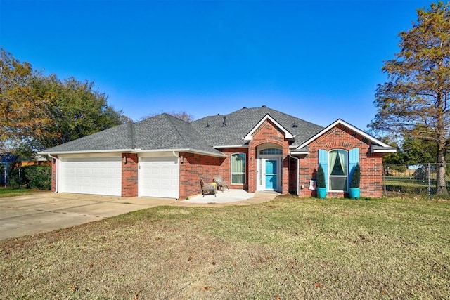 ranch-style home with a garage and a front lawn