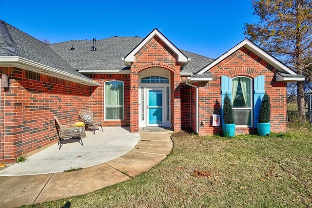 rear view of property with a patio and a yard