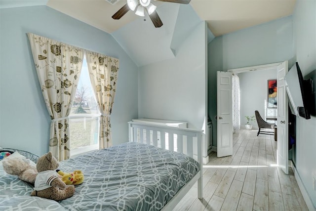 bedroom with lofted ceiling, ceiling fan, and light hardwood / wood-style floors