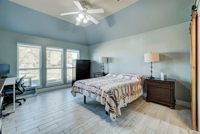 bedroom with lofted ceiling, ceiling fan, and light hardwood / wood-style flooring