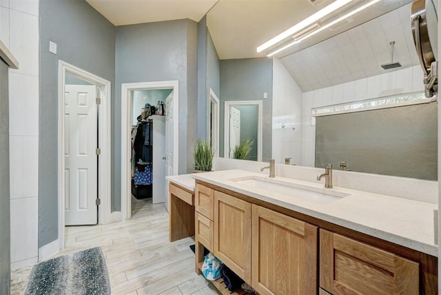 bathroom with hardwood / wood-style floors, walk in shower, and vanity