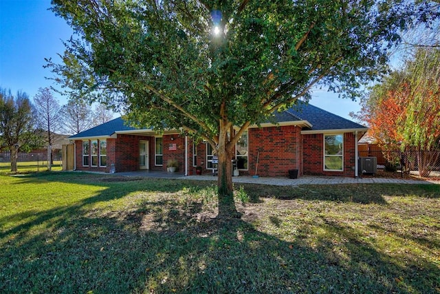 rear view of property featuring a yard