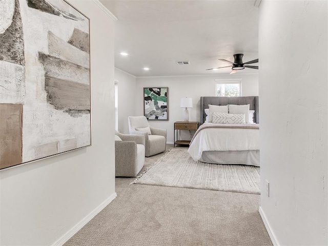 bedroom featuring ceiling fan, light colored carpet, and ornamental molding