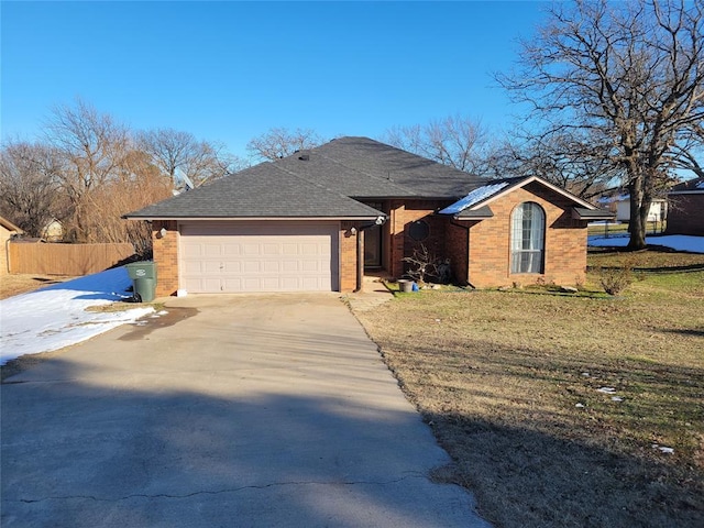 ranch-style house with a garage and a front lawn