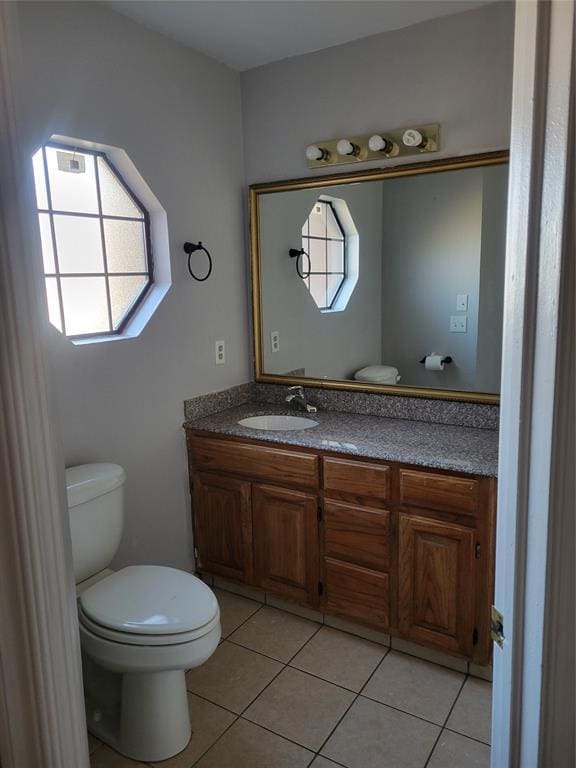 bathroom featuring tile patterned floors, vanity, and toilet