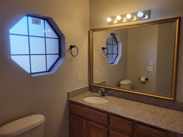 bathroom with toilet and vanity