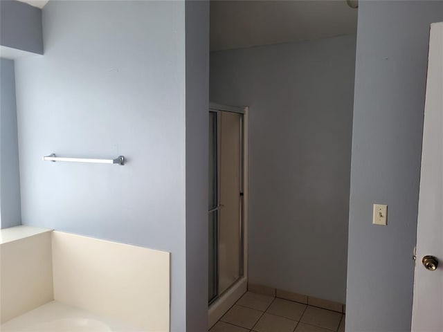 bathroom with tile patterned flooring and an enclosed shower