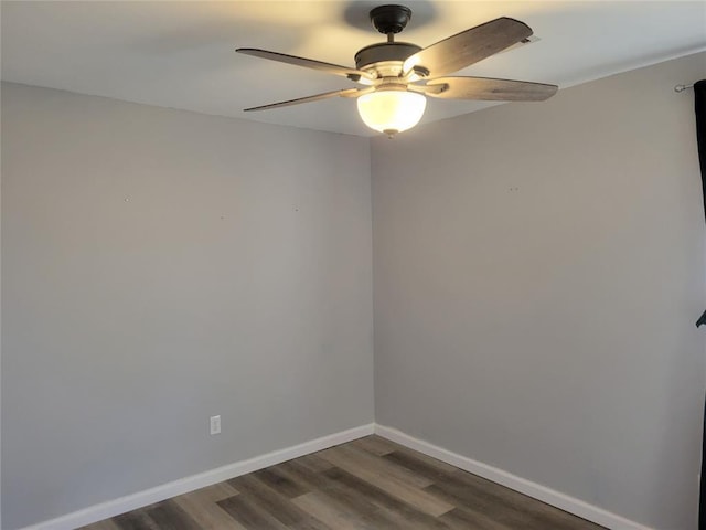 spare room featuring ceiling fan and dark hardwood / wood-style flooring