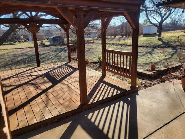 deck with a yard and a shed