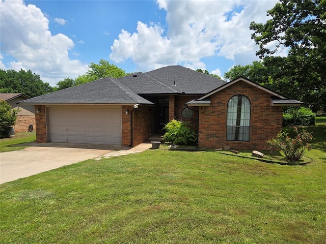 812 S Jessica Way, Pauls Valley, OK 73075 - single story home featuring an attached garage, concrete driveway, roof with shingles, and a front lawn
