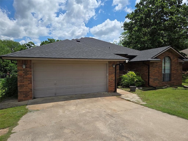 812 S Jessica Way, Pauls Valley, OK 73075 - single story home with brick siding, concrete driveway, an attached garage, a shingled roof, and a front lawn