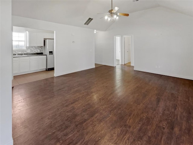 unfurnished living room featuring ceiling fan, dark hardwood / wood-style flooring, and lofted ceiling