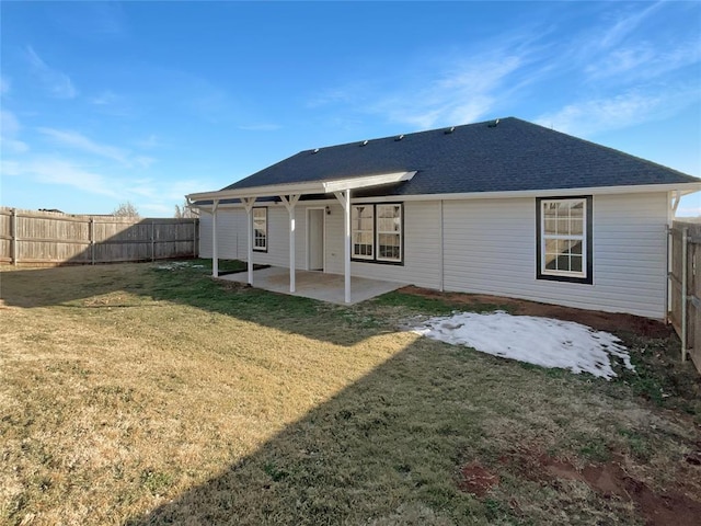 back of house with a lawn and a patio