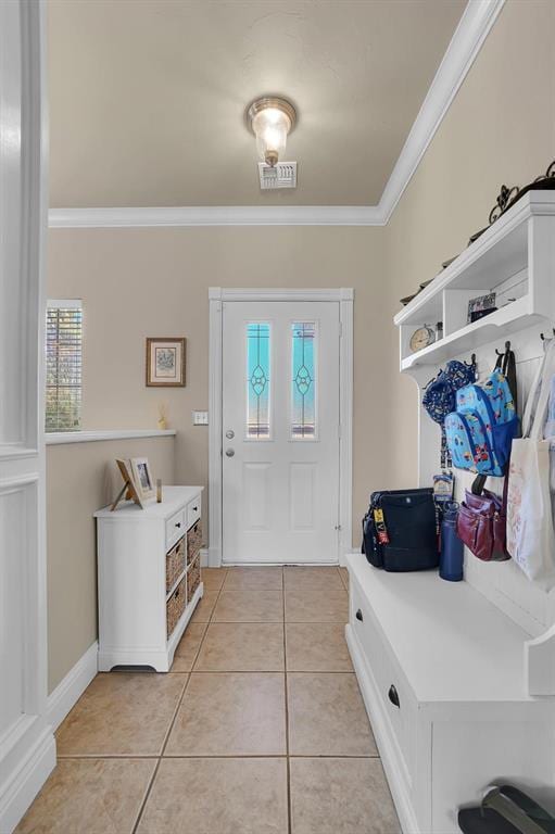 mudroom with light tile patterned floors and crown molding