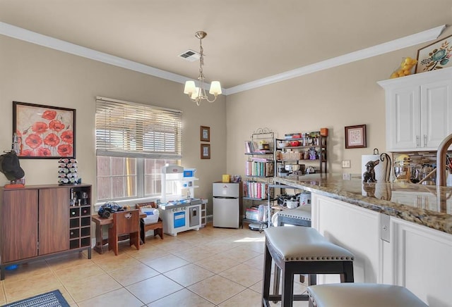 dining room featuring light tile patterned flooring, crown molding, and an inviting chandelier