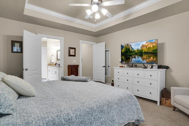 bedroom with ensuite bathroom, ceiling fan, a tray ceiling, crown molding, and light carpet