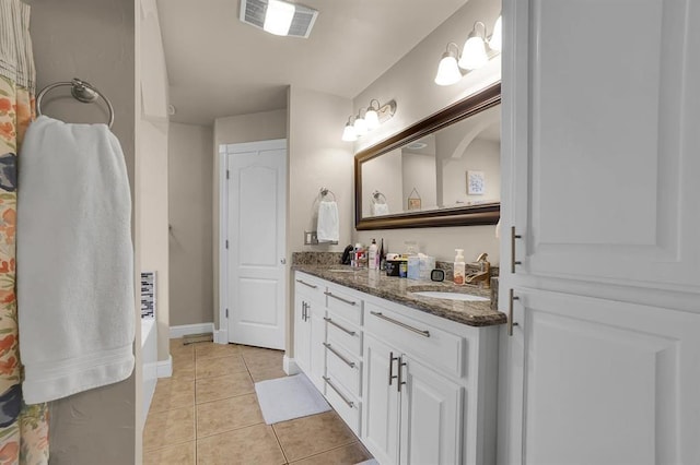 bathroom with tile patterned flooring and vanity