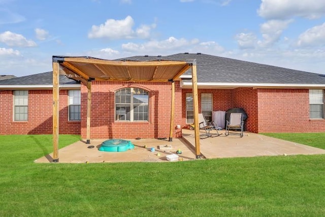 back of house with a yard and a patio