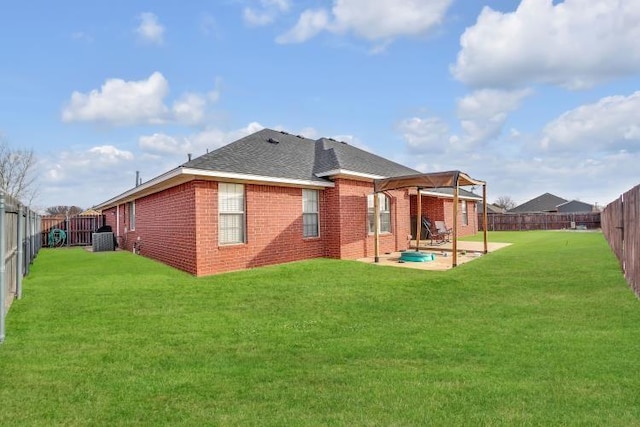 rear view of house with a patio and a yard