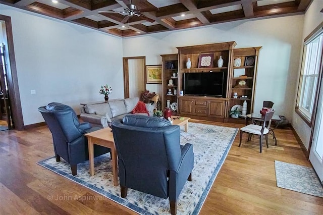 living room with light hardwood / wood-style floors, beam ceiling, ceiling fan, and coffered ceiling